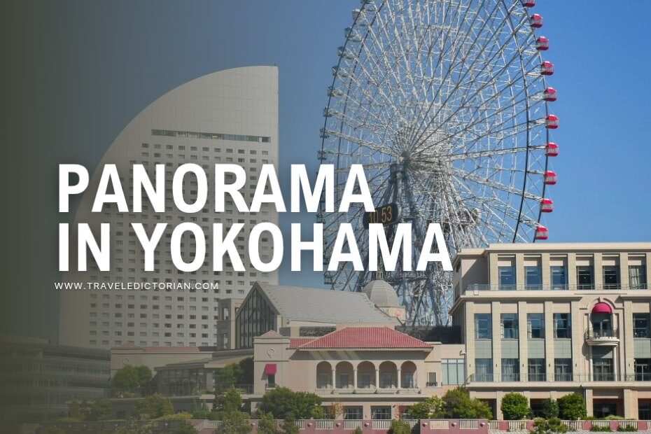 A cluster of modern buildings and a tall Ferris wheel