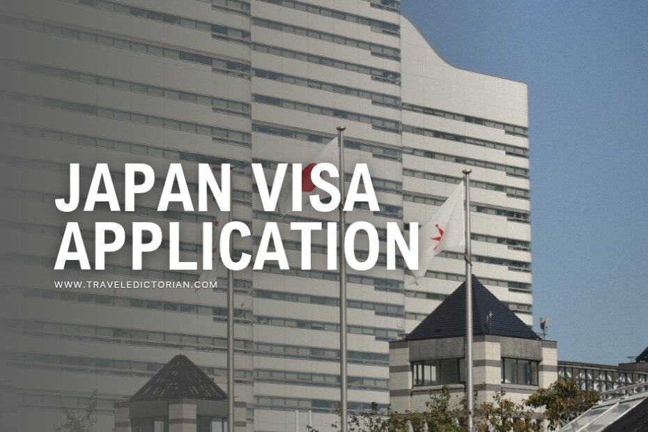 Three buildings behind Japanese flags on a pole